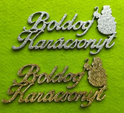 Csillámos ,fa alapú HDF(nem tömörfa)   ,ezüst-arany , boldog karácsonyt hóemberrel	2db/csomag	15x7cm 
