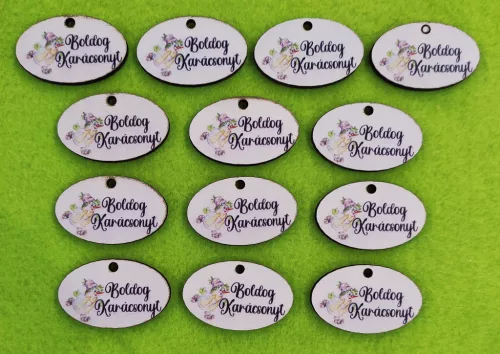  Nyomtatott fa ovális tábla korcsolyázós hóemberrel Boldog Karácsonyt felirattal	13db/csomag	4x2,5cm 